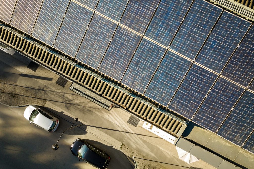 Aerial view of solar photovoltaic panels on a roof top of residential building block for producing
